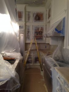 we used plastic to protect the appliances and counters while painting kitchen cabinets