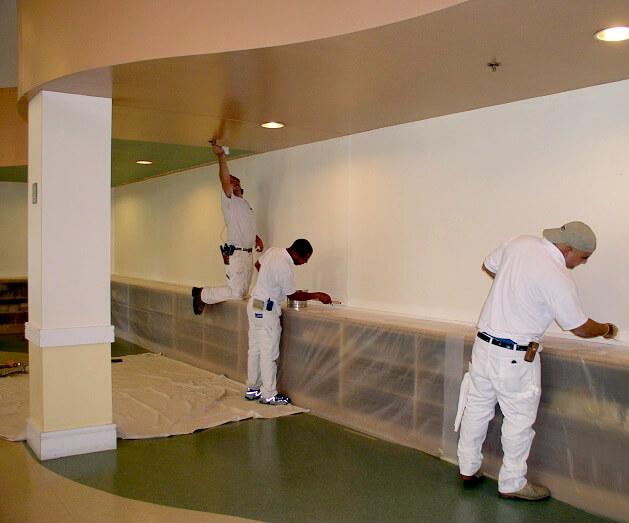 Our crew at work painting on a ceiling and walls