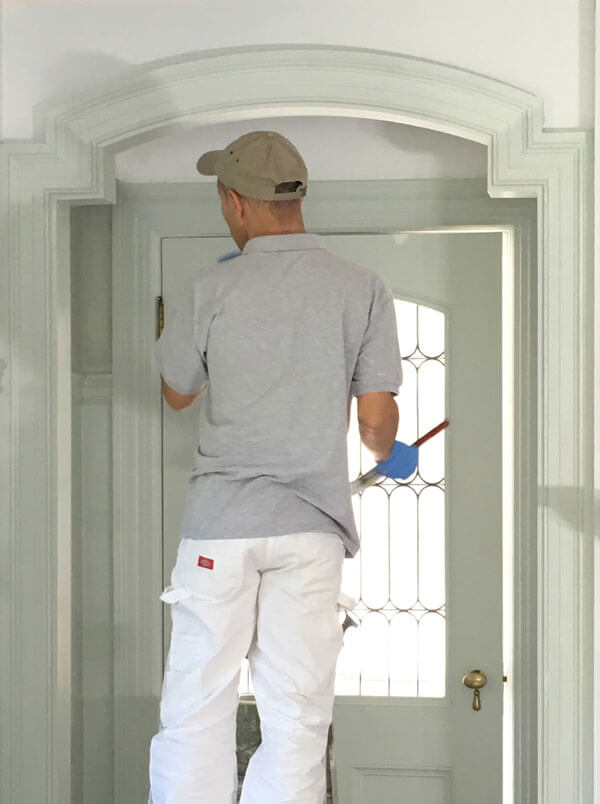 professional house painter using low voc paint