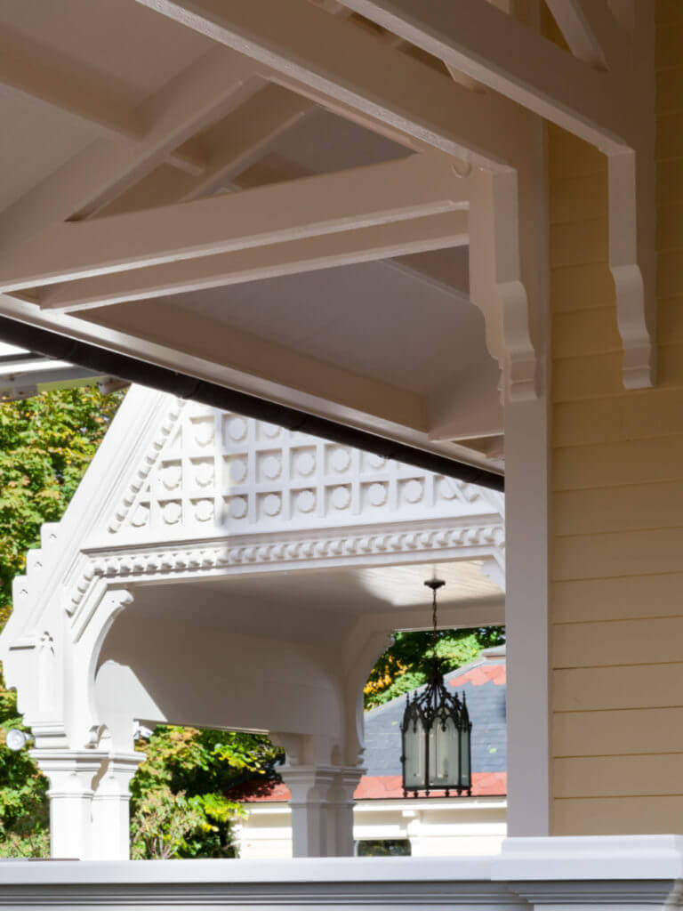 portico with triangular architecture featured at the top with yard view