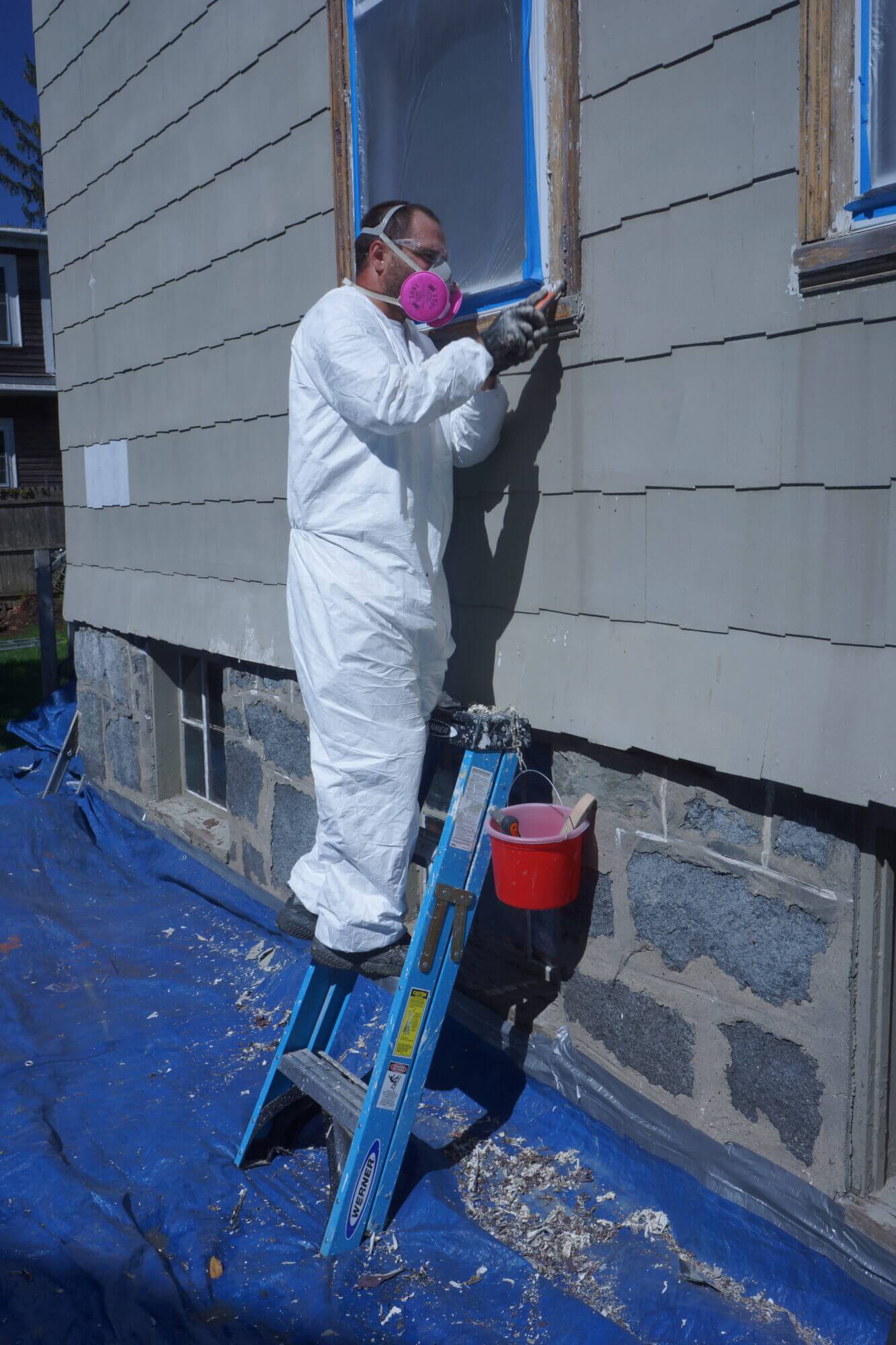 Catchlight employee working on trim of home exterior